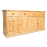 A large  antique victorian style country pine dresser base sideboard being raised on a plinth base