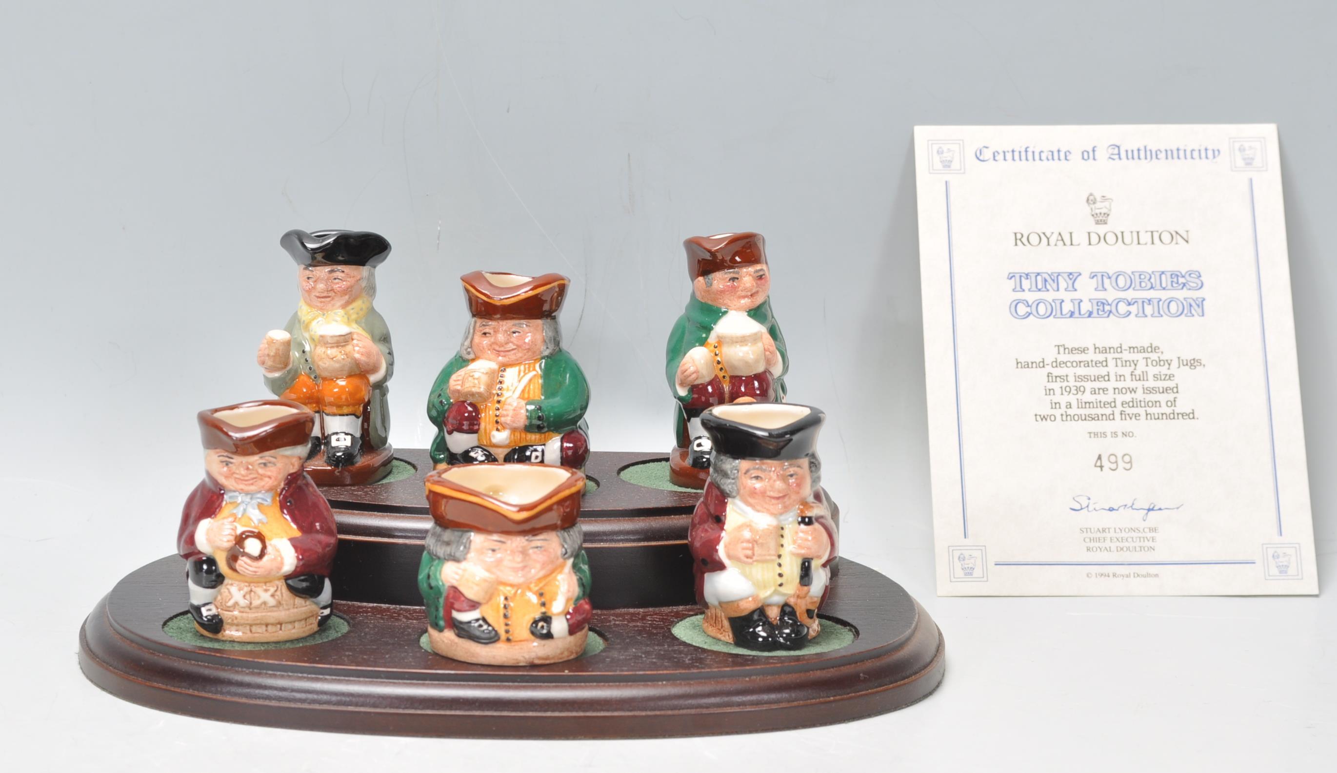 A group of six Royal Doulton miniature toby jugs from the Tiny Tobies collection, presented on a