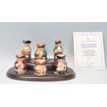 A group of six Royal Doulton miniature toby jugs from the Tiny Tobies collection, presented on a