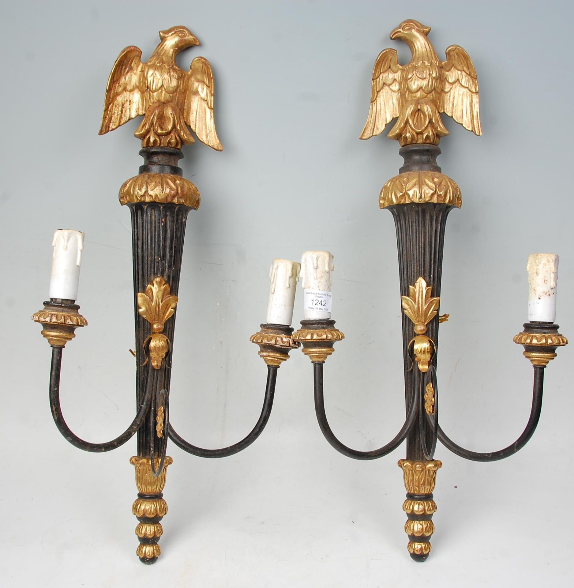 A pair of 20th Century gilt wall mounting candelabra lights having ebonised reeded wall mounts