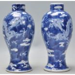 A pair of late 19th Century Chinese blue and white baluster vases having hand painted pairs of