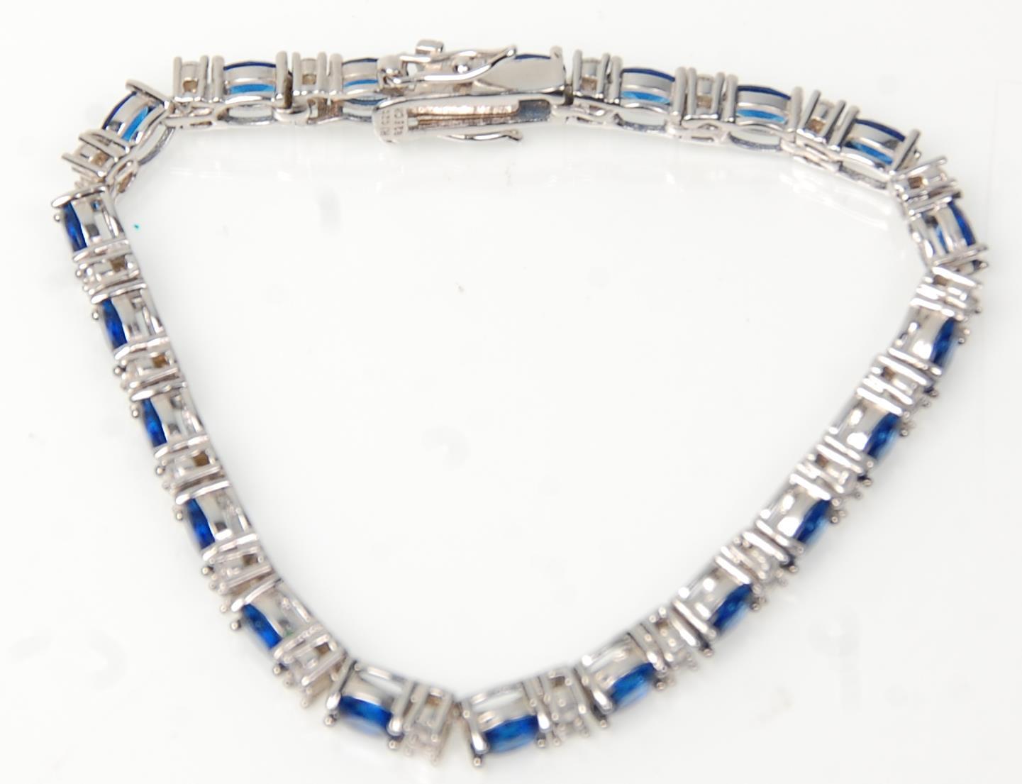 A stamped 925 silver tennis bracelet being set with oval cut blue stones with round cut white - Image 2 of 5