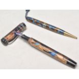 A pair of vintage 20th Century writing pens each having blue and brown mottled celluloid cases to