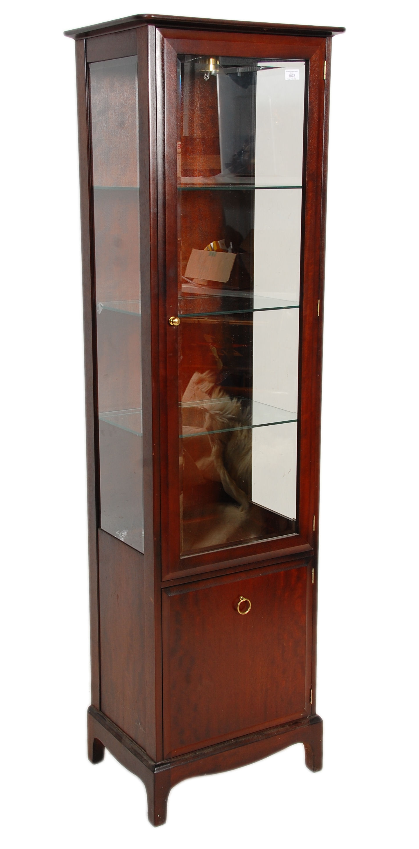 A 20th Century mahogany stag minstrel display cabinet having a cupboard base with ring handle to the