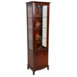 A 20th Century mahogany stag minstrel display cabinet having a cupboard base with ring handle to the