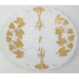 A 19th Century German Meissen porcelain plate having gilded vine decoration with moulded details.