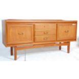 A vintage 20th century teak wood sideboard having a central bank of three drawers flanked by