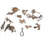A great group of seventeen silver charms to include a bedpan, Victorian shoe, 2x feathers, 2x boats,