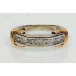 A stamped 9ct two tone gold half eternity ring channel set with eight round cut diamonds. Weight 3.
