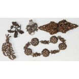 A group of five pieces of silver and marcasite ladies jewellery to include brooches and a decorative