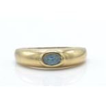 A 9ct gold and sapphire dome ring. The ring set with oval facet cut sapphire in domed ring with