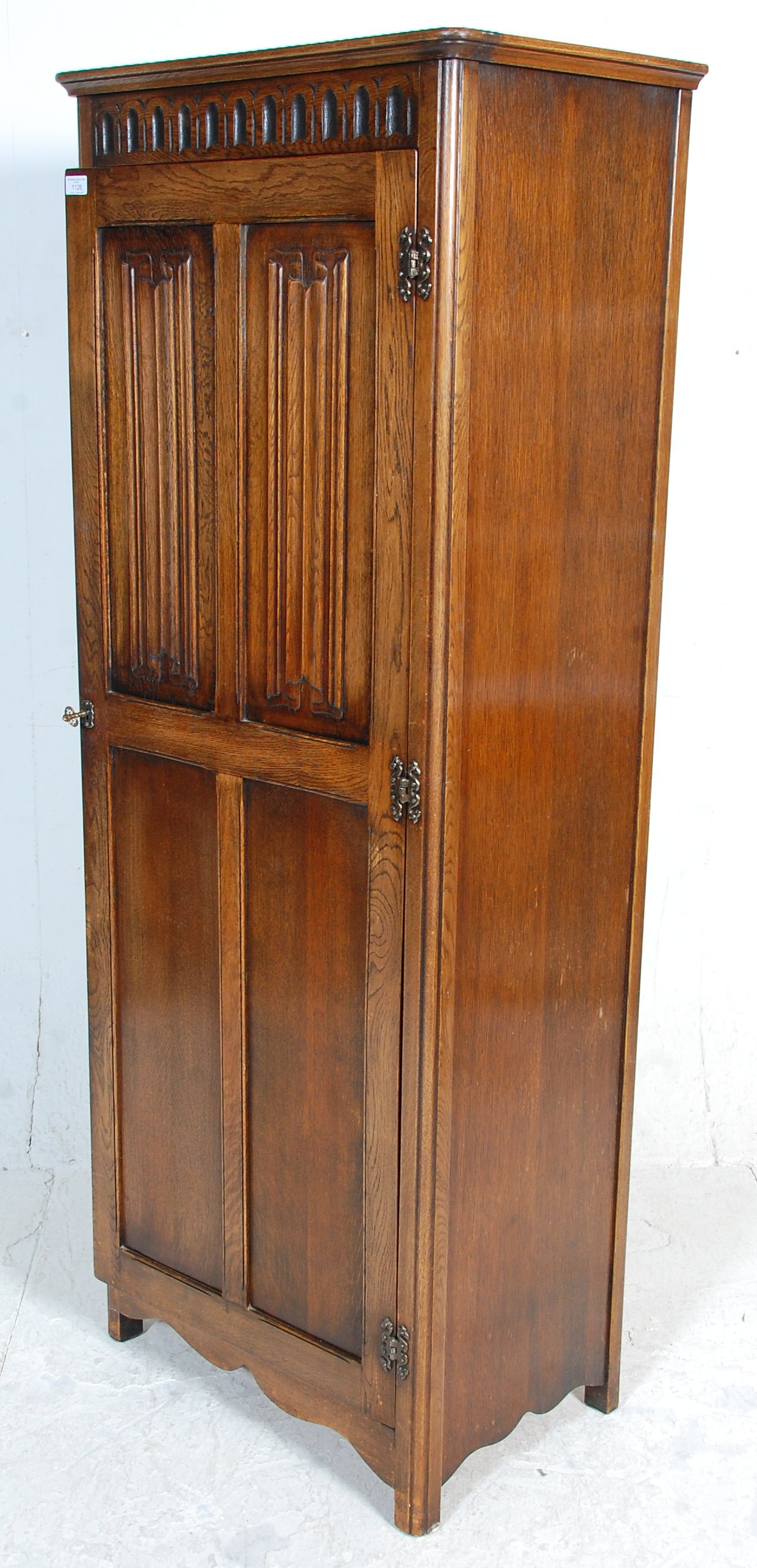 A 1930's oak Art Deco wardrobe having a singe four panelled door with carved graphic decoration to - Image 5 of 5