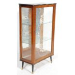 An 20th Century Art Deco walnut veneer display china cabinet having a glazed single door flanked