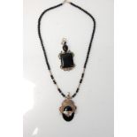 A twentieth century silver pendant necklace with a beaded black onyx chain and an oval onyx