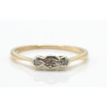 A 9ct gold platinum and diamond 3 stone ring. The ring set with 3 illusion set diamonds in