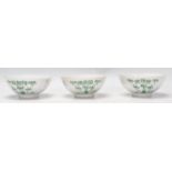 A set of three 19th Century Chinese footed bowls having a white ground enamelled with bamboo and