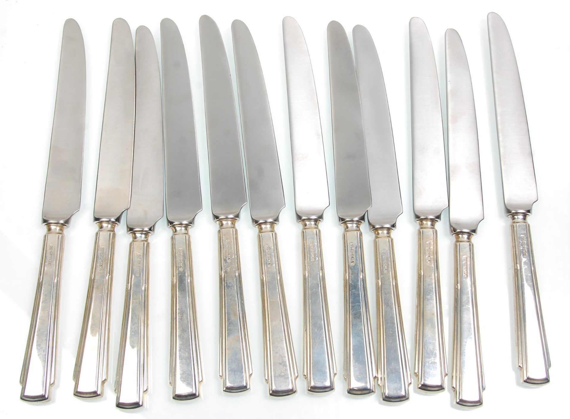 A set of 12 Yates Brothers silver handled knives, having stepped form handles. Each handle