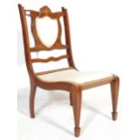 A 19th century VIctorian mahogany inlaid nursing chair. The chair raised on square tapering legs