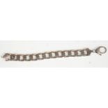 A thick and heavy silver flat link chain gentlemens bracelet having a lobster clasp. Total weight