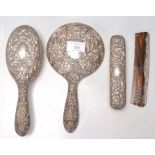 An mid 20th Century silver backed dressing table set having scrolled repousse decoration