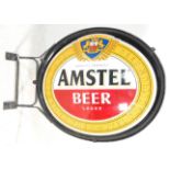 A good advertising Amstel Beer / Lager light box of oval form mounted to an iron bracket. H105cm
