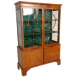 An early 20th Century 1930' Art Deco walnut china display cabinet having a cupboard base with twin