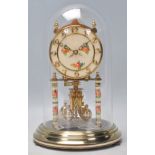 A vintage 20th Century German Kundo brass anniversary mantel clock having a a cream enamelled face