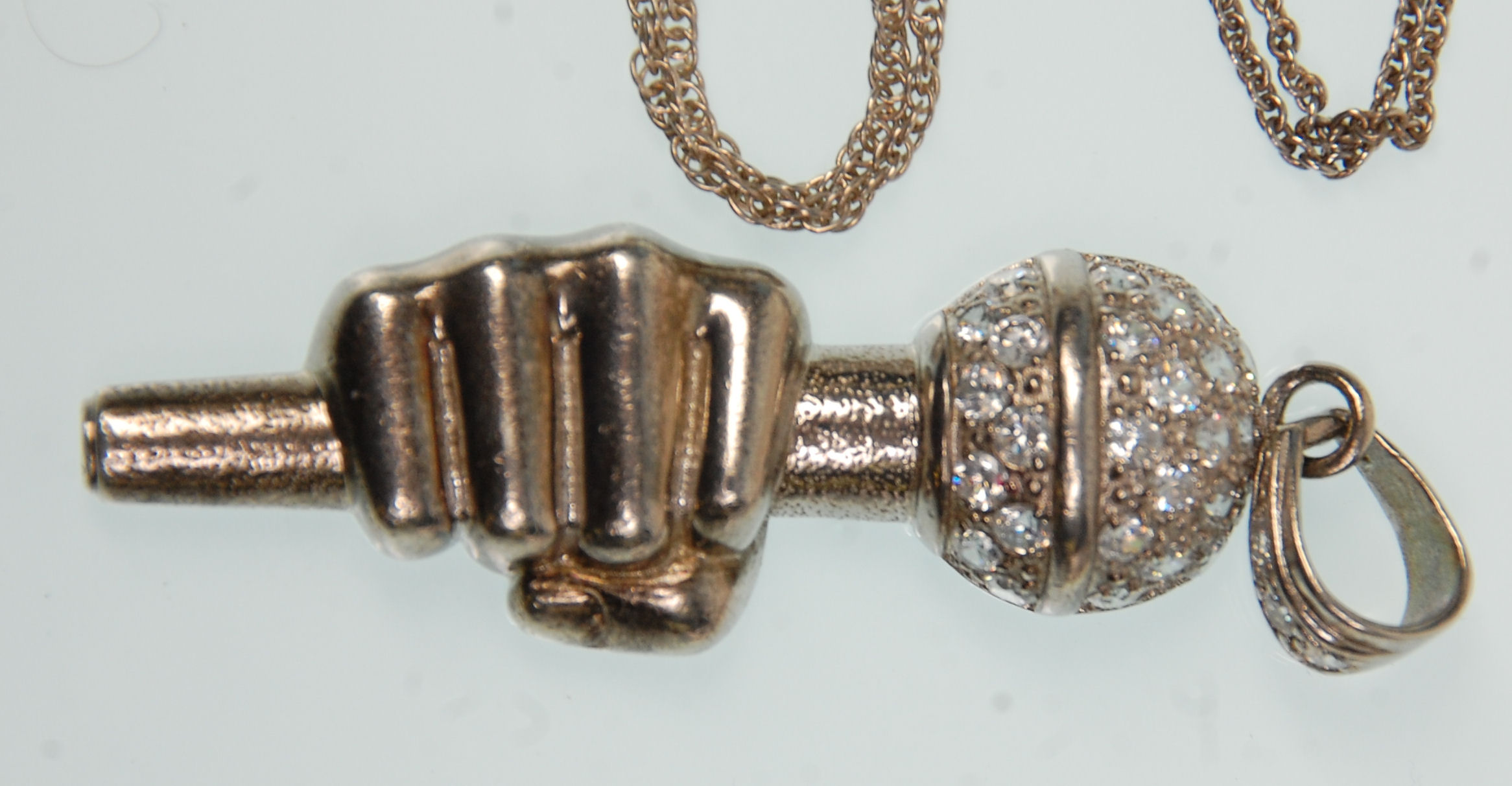 A group of silver chains and pendants to include a large pendant in the form of a hand holding a - Image 2 of 5