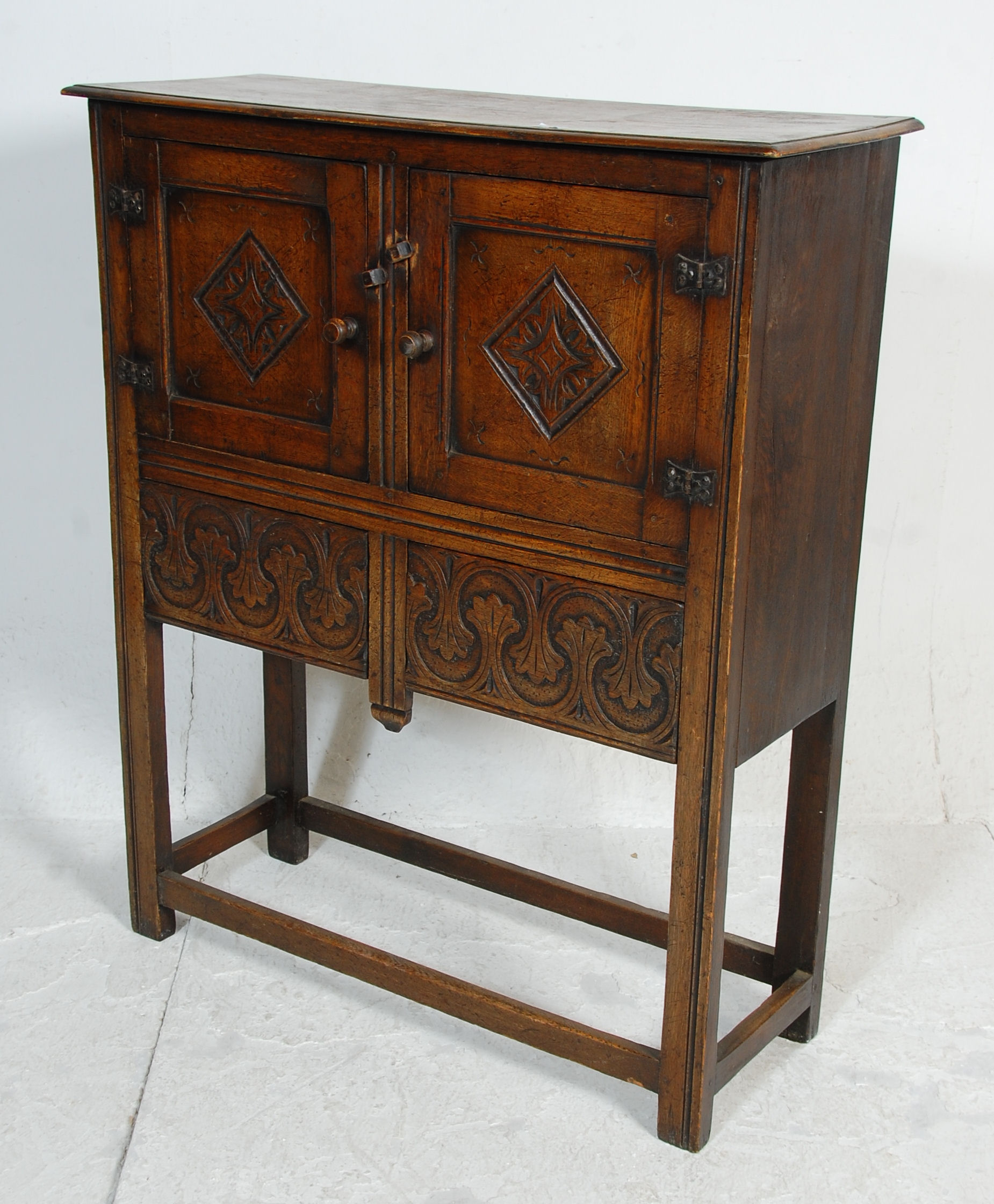 An early 20th Century 1920's carved Ipswich oak cupboard on stand having a twin door cupboard with - Image 8 of 8