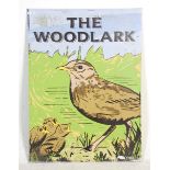 A large enamelled pub sign for ' The Woodlark ' having a graphic bird and chicks design. 113 cm x 82
