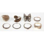 A collection of eight ladies silver rings to include two wishbone rings set with marcasites, a