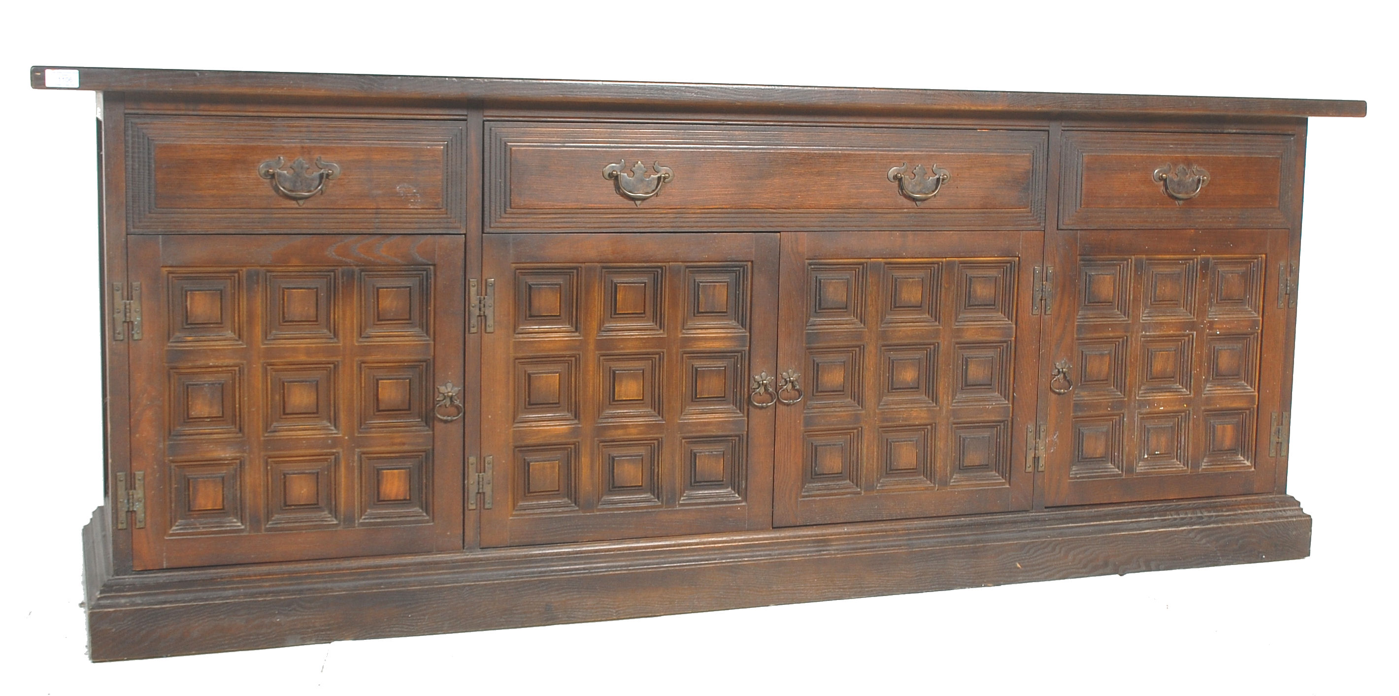 A mid century Spanish influence large carved oak sideboard / dresser base with portcullis relief