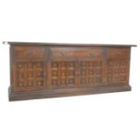 A mid century Spanish influence large carved oak sideboard / dresser base with portcullis relief