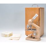 A vintage Minipet ASA KL-4 microscope set within its original wooden case complete with glass slides