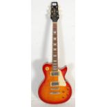A Vantage Les Paul style electric six string guitar having inlaid fretboard, a cream scratch