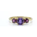 A 9ct gold Birmingham hallmarked 3 stone amethyst ring. The 3 round mixed cut amethysts in 4 prong
