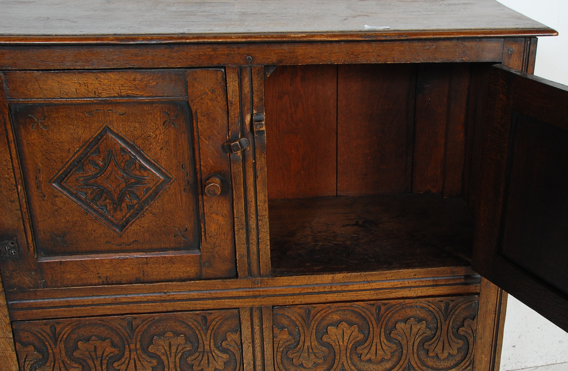 An early 20th Century 1920's carved Ipswich oak cupboard on stand having a twin door cupboard with - Image 5 of 8