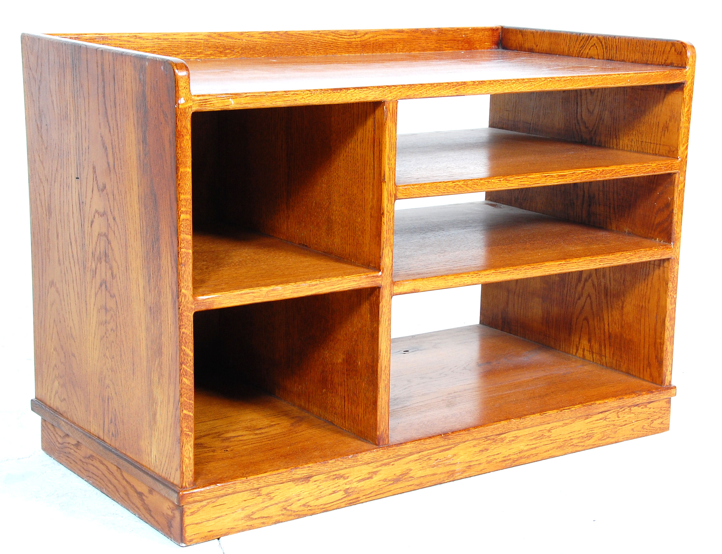 An 20th Century oak office storage unit / entertainment unit having a gallery top with sectional