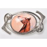 A stamped silver horse riding / equestrian brooch having a central oval panel enamelled with a