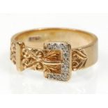A good hallmarked 9ct yellow gold buckle ring set with diamonds and having decorative engraved