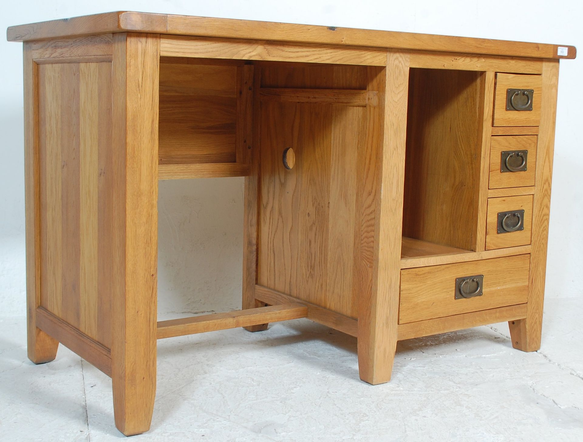 A contemporary chunky oak furniture land inspired golden oak desk having an open kneehole recess