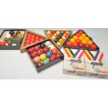 A collection of vintage snooker balls from various assorted sets along with wooden triangles and