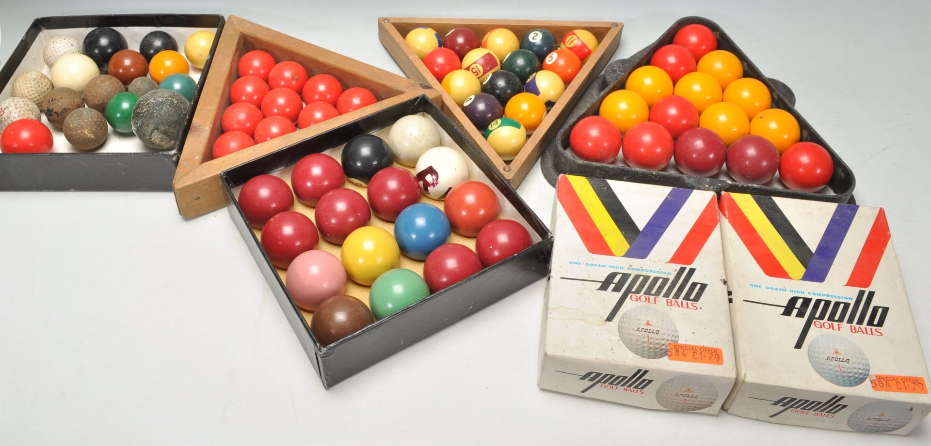 A collection of vintage snooker balls from various assorted sets along with wooden triangles and