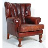 A 20th Century antique revival Chesterfield wingback armchair upholstered in oxblood leather