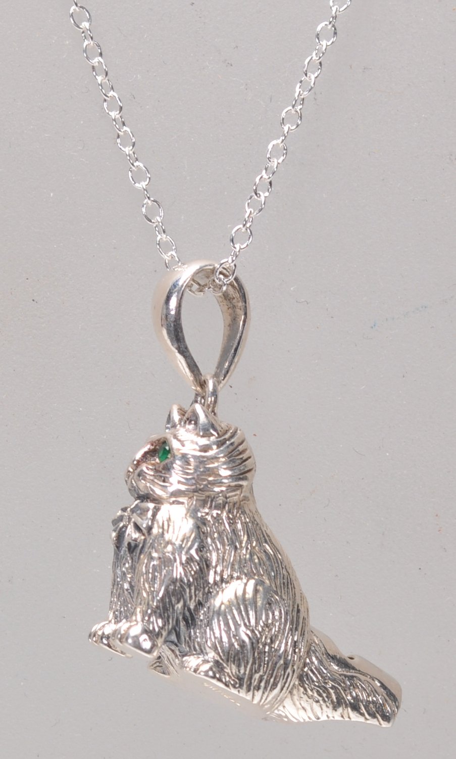 A stamped sterling silver pendant whistle in the form of a cat being set with green stone eyes and - Image 3 of 5