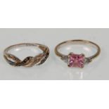 Two 9ct white gold ladies rings. One set with a square cut pink stone flanked by CZs. Hallmarked for