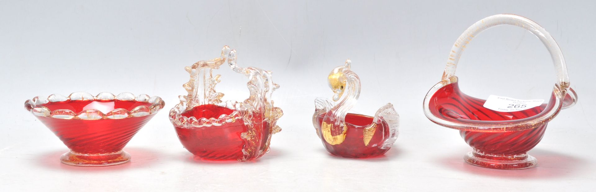 A group of 20th Century Venetian Murano glass ruby glass ornaments to include a spiral form