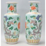 A pair of late 19th / early 20th Century Chinese baluster vases having hand enamelled decoration