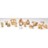 A group of fourteen Harmony Kingdom resin figurines in the form of animals to include racing