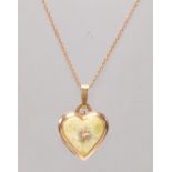 A stamped 14ct gold heart shaped pendant set with a green stone panel with a three leaf clover